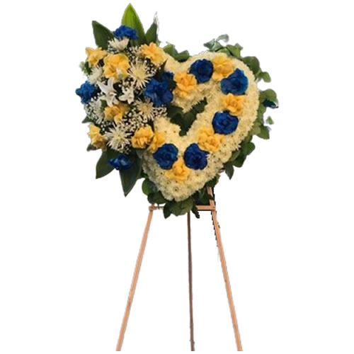 Medium heart with yellow roses and blue roses with a bouquet next to roses of the same colors, spider, white lily, baby breath, lemon leaf next to it