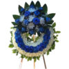 Blue rose funeral wreath with bouquet on top, spider, and baby's breath.