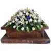 Casket with white rose and blue delphinium, white lilies, white snapdragon, white spider and baby breath