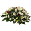 White and red rose casket, white carnations, white lilies, and baby’s breath