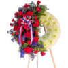 Large wreath with a bouquet on the side, red rose, blue delphinium and red carnations