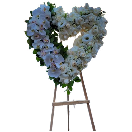 Large all white heart half white orchids and half white roses with spray roses, white lisianthus and baby breath