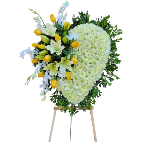 Large heart filled with a bouquet on the side with yellow roses, white lilies and