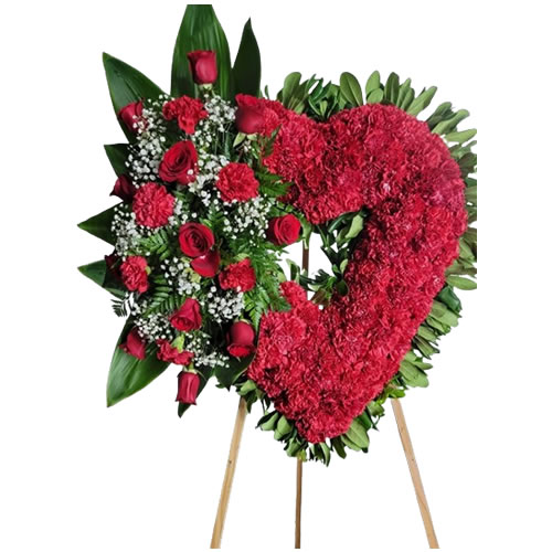 Large heart filled with carnations with a bouquet next to it with red roses and carnations and baby Breath